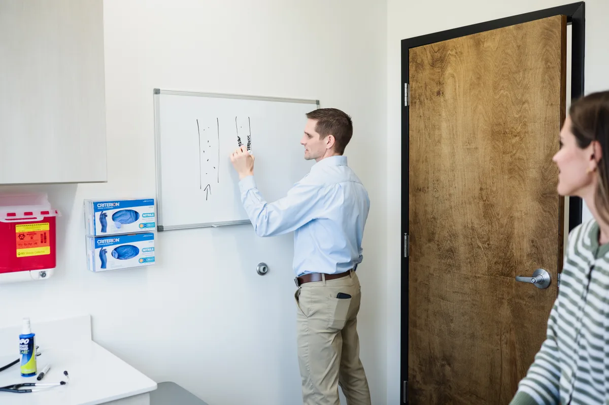 Dr. David Merrell explaining care options during a Direct Primary Care visit